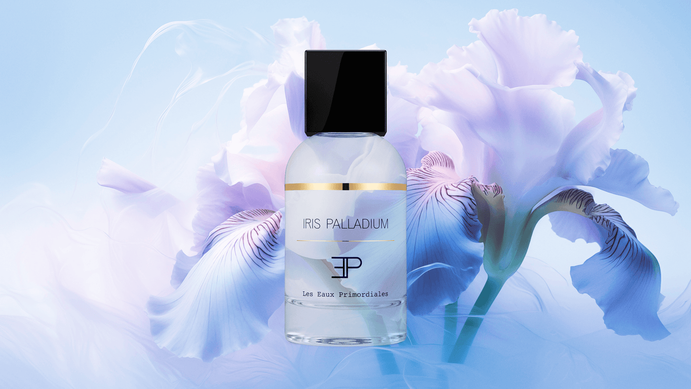 Les Eaux Priomordiales Iris Palladium clear cylindrical perfume bottle with square black top, superimposed over giant lavender iris flowers. 