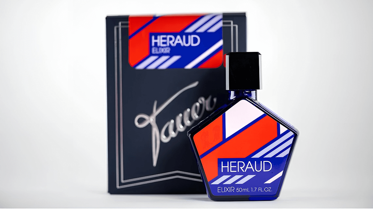 Tauer Heraud blue glass hexagonal perfume bottle with red/white/blue label and blue box.